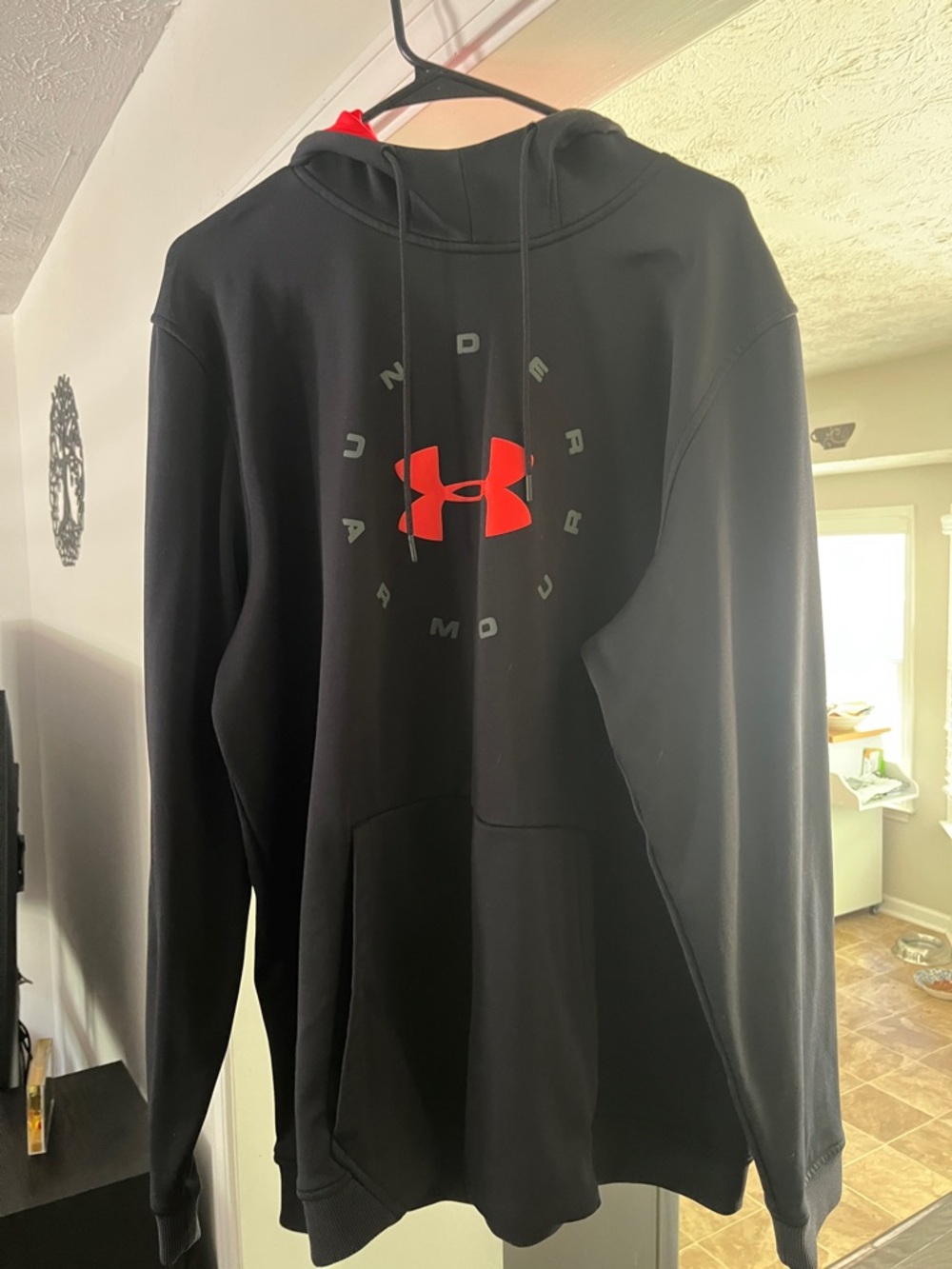 Under Armour Men’s Black Hoodie with vibrant orange Logo Accent